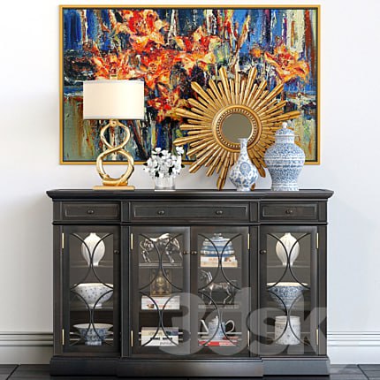 A chest of drawers with a collection of decor, a lamp and a set of sculptures