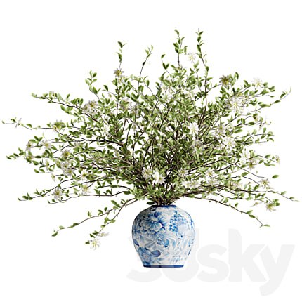 A bouquet of tree branches inserted into a celadon ceramic pot