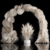 Wedding arch made of dry palm branches and pampas grass